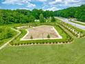 Aerial view of fenced community dog park with play area, walking path, and green space at 736 Georgias Landing Pkwy # 7, Raleigh, NC 27603
