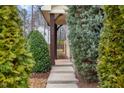 View of home's entrance with well-manicured landscaping and pavers leading to the front door at 752 Wickham Ridge Rd, Apex, NC 27539