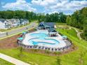 Aerial view of the neighborhood pool and clubhouse with lounge chairs and umbrellas at 756 Georgias Landing Pkwy # 3, Raleigh, NC 27603