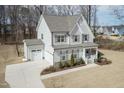 Beautiful two-story home with attached garage and classic architectural details and manicured lawn at 76 Freewill Pl, Raleigh, NC 27603