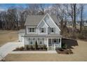 Charming two-story home featuring a welcoming front porch and well-maintained landscaping at 76 Freewill Pl, Raleigh, NC 27603