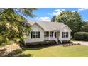 Lovely single-story home with a manicured lawn, inviting porch, and lush landscaping at 765 S Hollybrook Rd, Wendell, NC 27591