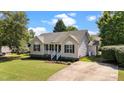 Inviting single-story home with a well-maintained lawn and a long driveway at 765 S Hollybrook Rd, Wendell, NC 27591