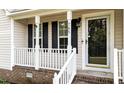 Close-up of the charming front porch with white railings and black shutters at 765 S Hollybrook Rd, Wendell, NC 27591