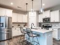 Kitchen with white cabinets, stainless steel appliances, granite countertop, and breakfast bar at 80 Willow Green Dr, Clayton, NC 27527