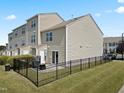 Rear view of a townhome featuring a fenced yard with a patio and sliding glass door at 100 Stratford Lakes Dr # 361, Durham, NC 27713
