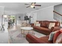 Open-concept living room featuring hardwood floors and modern décor flowing into the dining and kitchen areas at 100 Stratford Lakes Dr # 361, Durham, NC 27713