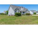 A charming single-Gathering home with a well-maintained lawn and gray siding at 104 Jj Dr, Benson, NC 27504
