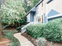 Charming home exterior featuring lush landscaping and a winding walkway, creating a serene outdoor space at 109 Virginia Pl, Cary, NC 27513