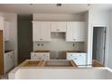 Bright kitchen featuring white cabinets and an island, ready for customization and personalization at 11121 Salers Loop, Middlesex, NC 27557
