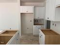 Bright kitchen with white cabinets, ready for appliances, offering a clean and modern design at 11121 Salers Loop, Middlesex, NC 27557