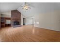 Spacious living room with a striking brick fireplace and hardwood flooring at 1131 Pulley Gordon Rd, Zebulon, NC 27597