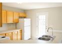 Well-lit kitchen featuring wood cabinets, a double sink, and modern appliances, ready for cooking at 12 Linsey Ct, Lillington, NC 27546
