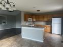Open concept kitchen with modern appliances, ample counter space, a kitchen island, and great natural light at 12 Linsey Ct, Lillington, NC 27546
