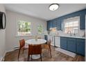 Cozy kitchen boasts stylish blue cabinets, white countertops, modern appliances, and a bright, airy eat-in area at 1208 W Murray Ave, Durham, NC 27704