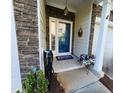 Charming front door entrance with stone details, welcoming flowers, and neutral finishes at 1309 Bartlett Cir, Hillsborough, NC 27278