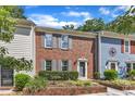 Traditional townhouses with brick and siding, accented by gray shutters and well-maintained front gardens at 1344 Baez St, Raleigh, NC 27608