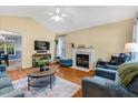 Cozy living room features hardwood floors, a fireplace, and comfortable furnishings at 135 Crooked Creek Run, Louisburg, NC 27549