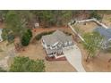 Aerial view of a charming two-story home, featuring a long driveway, and a large backyard with a shed at 138 Tramway Cir, Angier, NC 27501