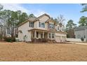 Charming two-story home with a well-maintained lawn and an attached two-car garage and a shed in the backyard at 138 Tramway Cir, Angier, NC 27501