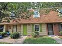 Exterior of a two-story home with a cozy front yard and a green front door for a welcoming entrance at 141 Jones Franklin Rd # E, Raleigh, NC 27606