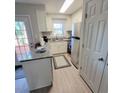 Well-lit kitchen features a combination of white cabinets, stainless steel appliances, and granite countertops at 141 Jones Franklin Rd # E, Raleigh, NC 27606