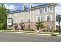 Beautiful three-story townhome showcasing the brick and siding exterior with multiple windows and landscaping at 1437 Newpoint Dr, Durham, NC 27713