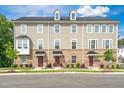 A stunning view of a three-story townhome showcasing a brick and siding exterior with multiple windows at 1437 Newpoint Dr, Durham, NC 27713