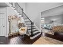 Elegant foyer boasts hardwood floors, a staircase with metal railings, and ornate decor at 1637 Dodford Ct, Wake Forest, NC 27587