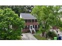 Aerial view of a traditional two-story brick house with green trees surrounding the property at 1937 Crag Burn Ln, Raleigh, NC 27604