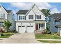 Beautiful two-story home featuring a two-car garage, a red front door, and a well-manicured lawn at 208 Dry Canyon Dr, Wendell, NC 27591