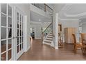 Bright, spacious foyer with hardwood floors and a staircase leading to the second level at 2135 Vittorio Ln, Apex, NC 27502