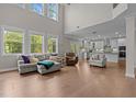 Expansive living room boasts soaring ceilings, abundant natural light, and an open floor plan at 2135 Vittorio Ln, Apex, NC 27502
