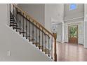 Elegant staircase with decorative iron railings and hardwood steps welcomes you into the home at 2135 Vittorio Ln, Apex, NC 27502