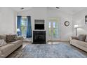 Inviting living room with a fireplace, french doors, and neutral-toned furniture at 3015 Winston Dr # 117, Burlington, NC 27215