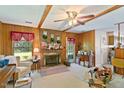 Cozy living room with wood paneling, a brick fireplace, and bright natural light at 305 Reynolds N Ave, Durham, NC 27707