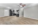 Open-concept living area with sleek black kitchen appliances and stylish tile flooring at 308 Lynn Road, Durham, NC 27703