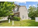 Well-manicured lawn surrounds this home with stone accents and tan siding at 3169 Diana Cir, Burlington, NC 27215