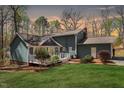 Lovely backyard featuring a well-maintained lawn, mature trees, and a deck at 3418 Carriage Trl, Hillsborough, NC 27278
