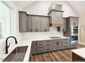 Modern kitchen features gray cabinets, stainless steel appliances, and quartz countertops at 35 Big Bear Dr, Pittsboro, NC 27312