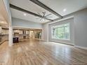 Bright living room with hardwood floors, ceiling fan, and expansive windows overlooking the outdoors at 35 Big Bear Dr, Pittsboro, NC 27312