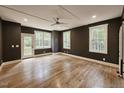 Spacious bedroom featuring hardwood floors, dark walls and large windows providing ample natural light at 35 Big Bear Dr, Pittsboro, NC 27312
