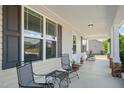 Spacious covered front porch with seating, providing an outdoor living space and views of the home's exterior at 357 Sherrill Farm Dr, Benson, NC 27504