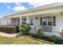 Inviting front porch with decorative plants and hanging flower baskets at 357 Sherrill Farm Dr, Benson, NC 27504