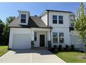 Attractive two-story home featuring white siding, a gray roof, and a beautifully landscaped front yard at 367 Whitley Ridge Dr, Clayton, NC 27527