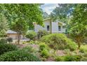Beautiful two-story home with lush greenery, mature trees, and well-maintained landscaping at 37 Wedgewood Rd, Chapel Hill, NC 27514