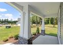 Wide front porch with stone accents and sturdy white support pillars provides ample outdoor space at 40 W Victoria Ridge Dr # 18, Selma, NC 27576