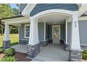 Close-up shot of an inviting front porch with gray stone accents and sturdy white support pillars at 40 W Victoria Ridge Dr # 18, Selma, NC 27576