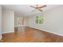 Bright living room featuring hardwood floors, a ceiling fan, and a view of the deck at 421 Ridgefield Rd Rd, Chapel Hill, NC 27517