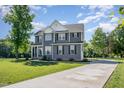Traditional home exterior with gray siding, black shutters, and a well-maintained front lawn at 45 Leighann S Ct, Timberlake, NC 27583